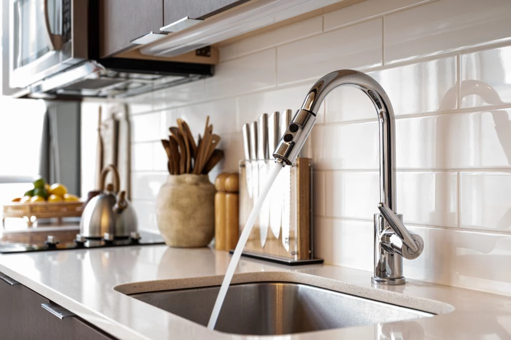 Kitchen sink with water coming out of the facet